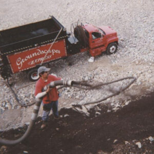 someone spraying earth blanket