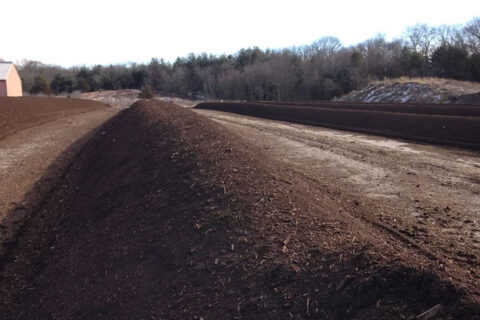 Large piles of soil in an outdoor field.