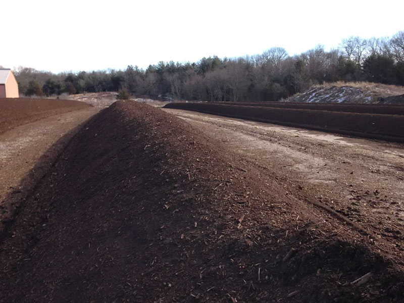 Large piles of soil in an outdoor field.